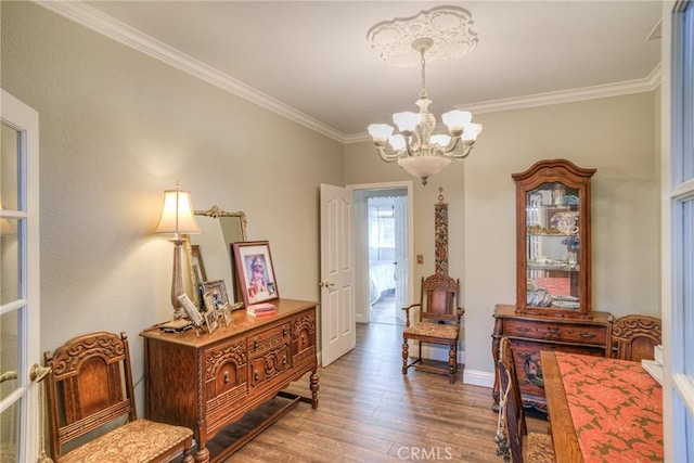 interior space with hardwood / wood-style flooring, crown molding, and a chandelier