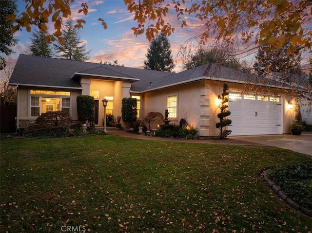 view of front of property with a lawn and a garage