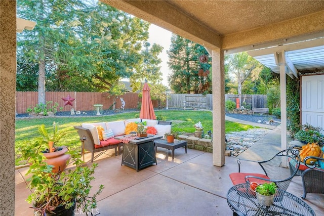 view of patio featuring an outdoor living space with a fire pit