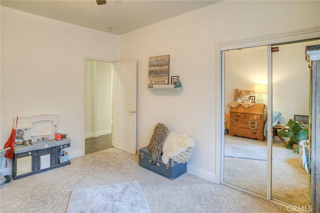 recreation room with light carpet and ceiling fan