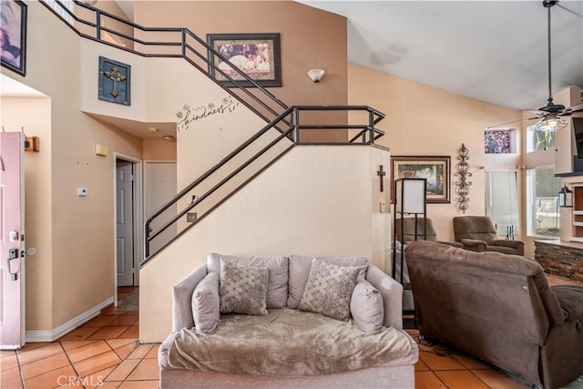 living room featuring ceiling fan, light tile patterned floors, and high vaulted ceiling