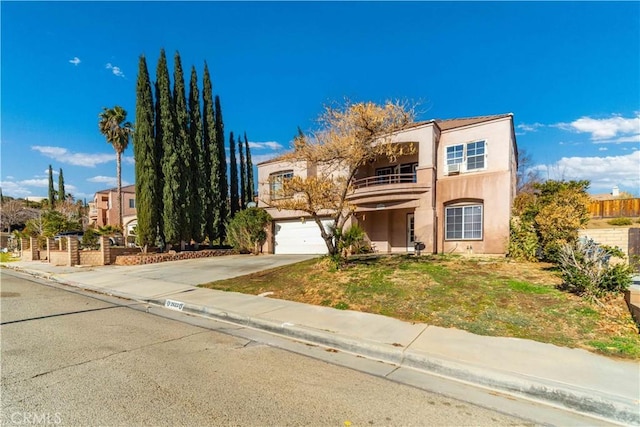 view of front of home with a garage and a balcony