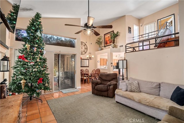 living room with ceiling fan, light tile patterned floors, and high vaulted ceiling