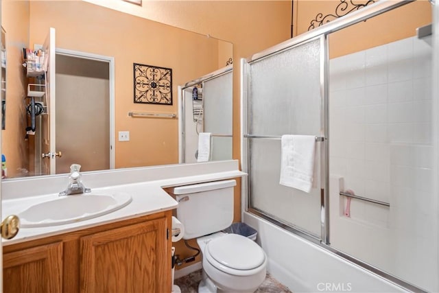 full bathroom with vanity, toilet, and bath / shower combo with glass door