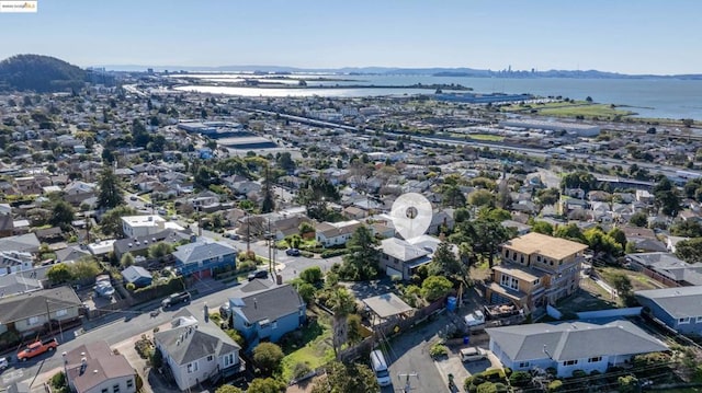 birds eye view of property with a water and mountain view