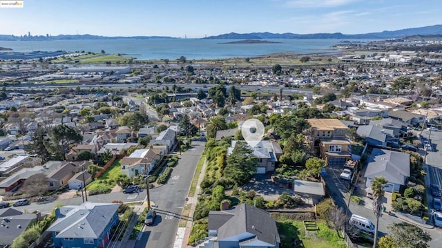 birds eye view of property featuring a water and mountain view