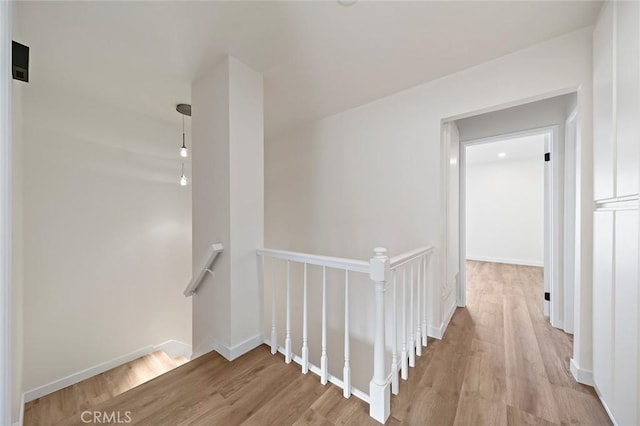 corridor with light hardwood / wood-style flooring