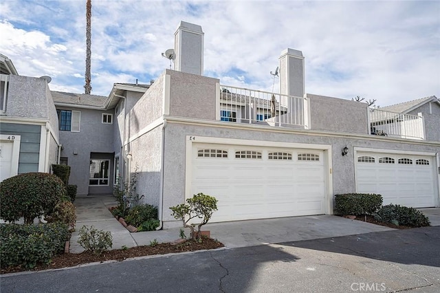 townhome / multi-family property with a balcony and a garage