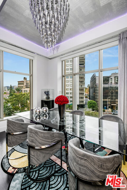 dining area with an inviting chandelier and hardwood / wood-style flooring