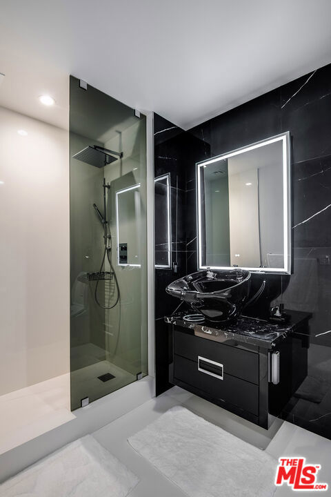 bathroom with a shower and vanity