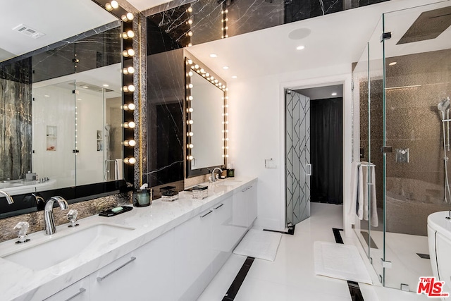 bathroom with tile patterned flooring, vanity, and a shower with door