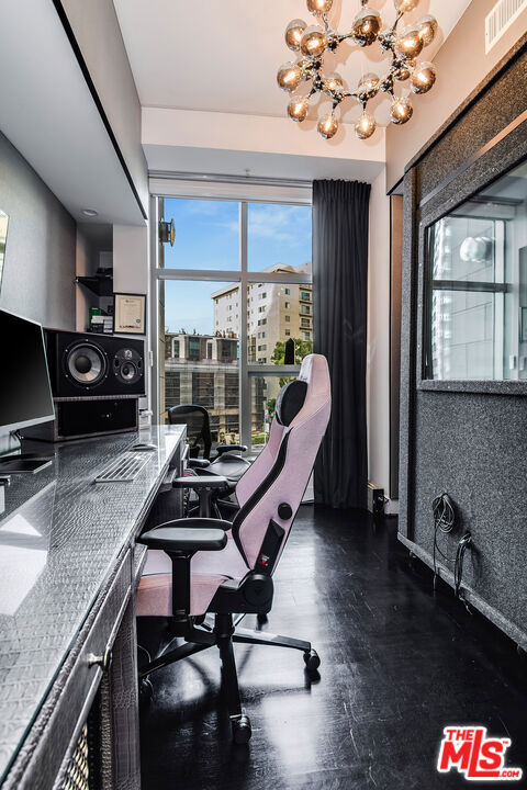 office area featuring an inviting chandelier and a healthy amount of sunlight