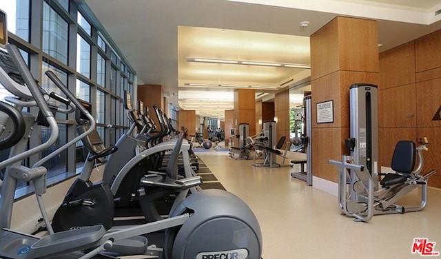 exercise room featuring wood walls