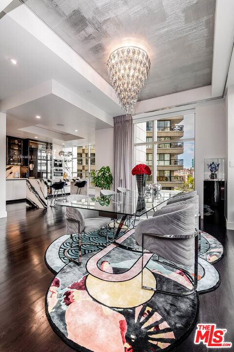 dining area featuring hardwood / wood-style floors, a tray ceiling, and a chandelier