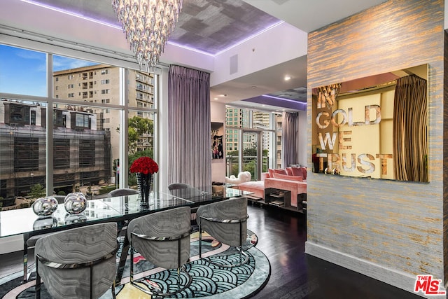 dining room featuring an inviting chandelier, wood-type flooring, and plenty of natural light