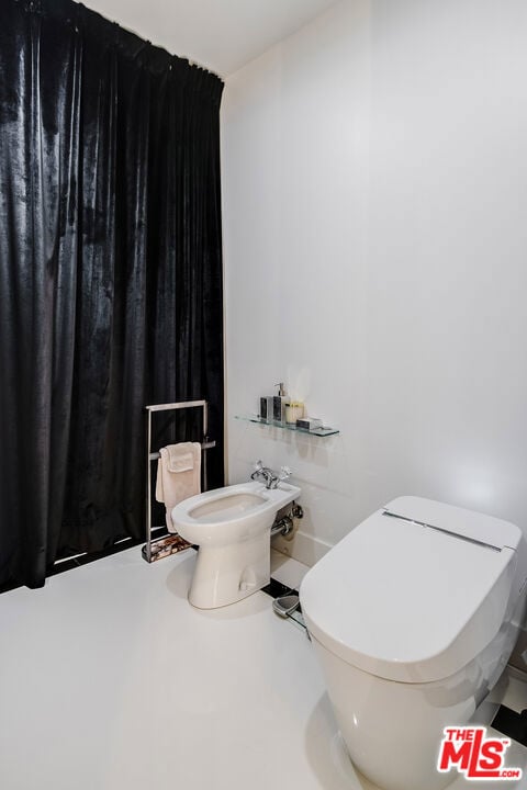 bathroom with a bidet and toilet