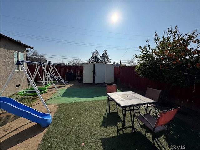 view of yard with a playground and a shed