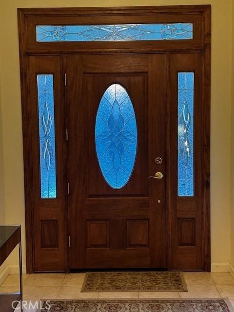 foyer entrance with light tile patterned floors