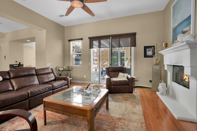 living room featuring light hardwood / wood-style flooring and ceiling fan