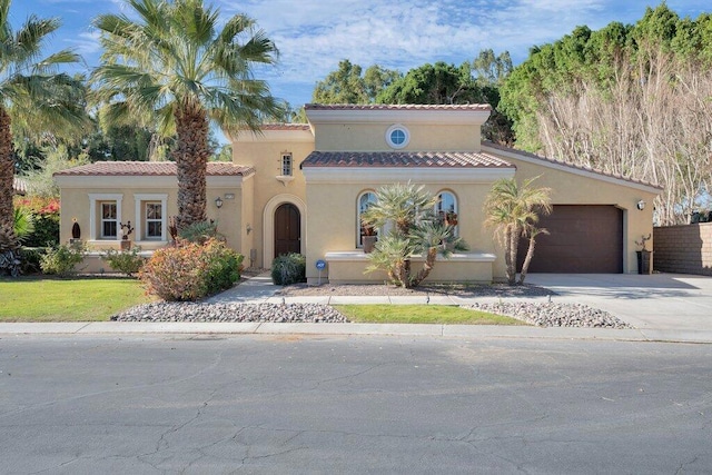 mediterranean / spanish home featuring a garage