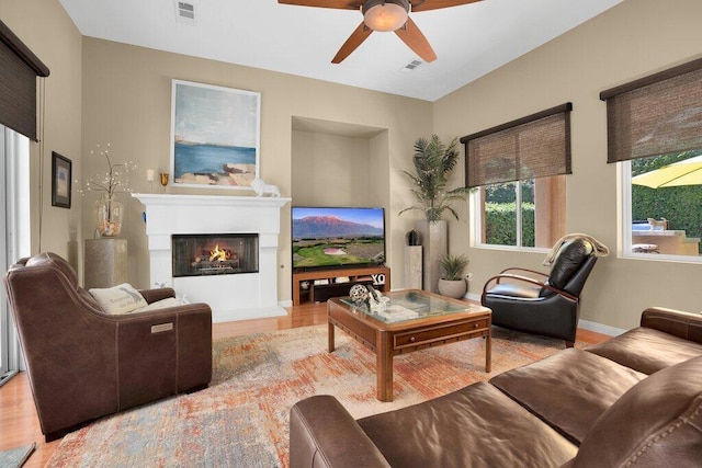 living room featuring light hardwood / wood-style flooring and ceiling fan