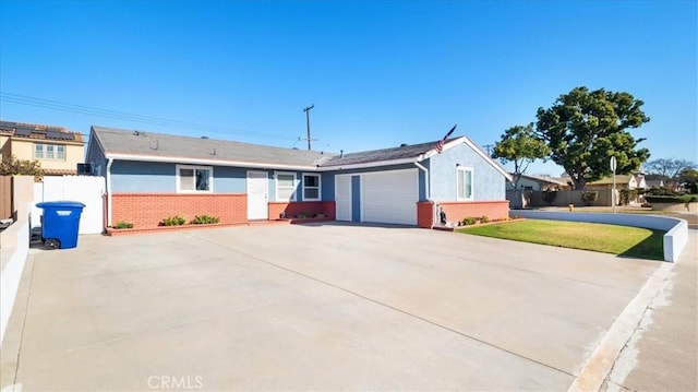 single story home featuring a front yard and a garage