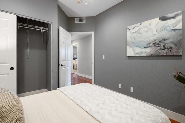 bedroom with a closet and hardwood / wood-style floors