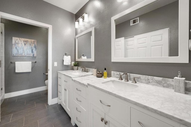 bathroom featuring vanity, toilet, and tile patterned floors