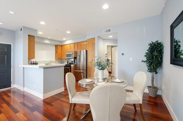 dining room with dark wood-type flooring and sink