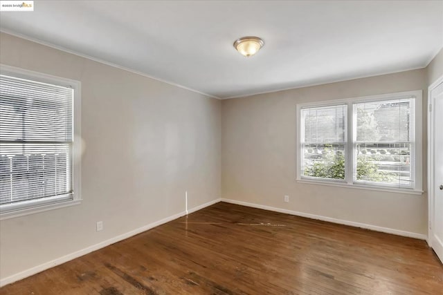 unfurnished room with dark hardwood / wood-style flooring