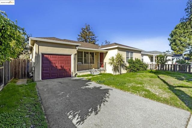 ranch-style home with a garage and a front lawn