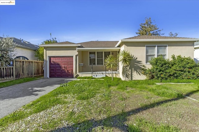 single story home featuring a garage and a front lawn