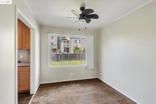 unfurnished dining area featuring ceiling fan and dark wood-type flooring