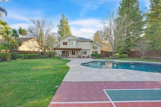 view of pool with a lawn, a patio area, and a hot tub