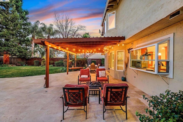 patio terrace at dusk with a pergola, a yard, and an outdoor living space with a fire pit