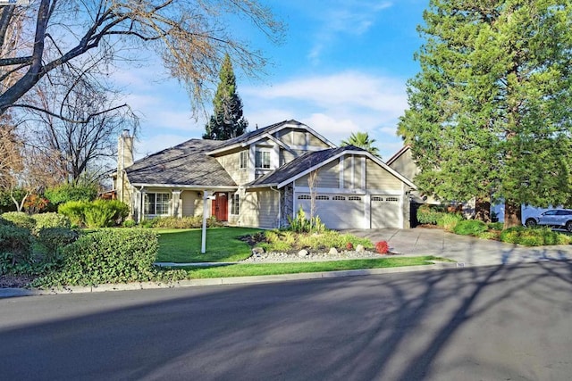 view of front of house with a garage and a front lawn