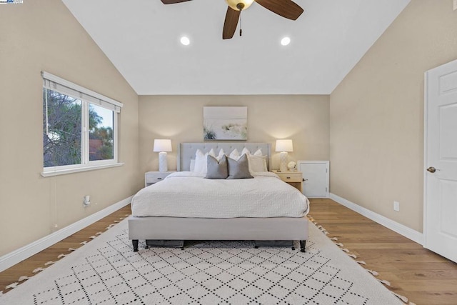 bedroom featuring light wood-type flooring, ceiling fan, and lofted ceiling