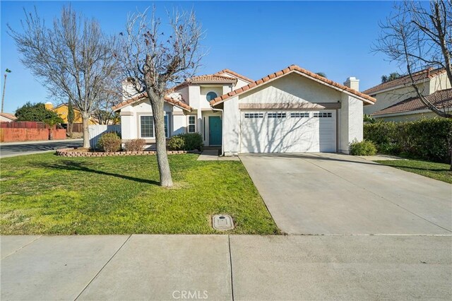 view of front of house with a garage and a front lawn