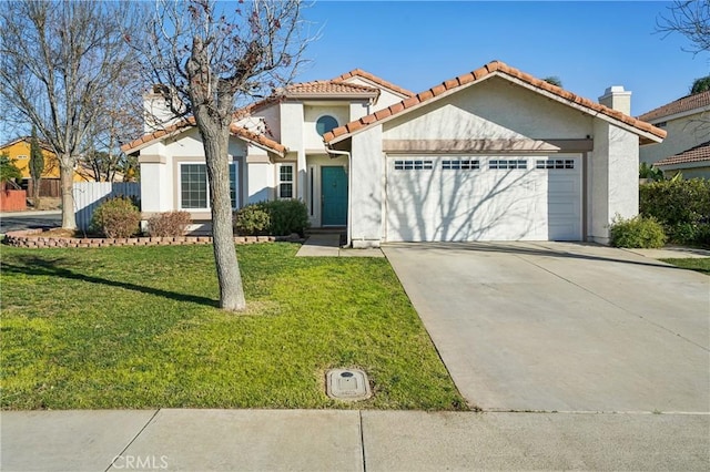 view of front of house with a garage and a front lawn