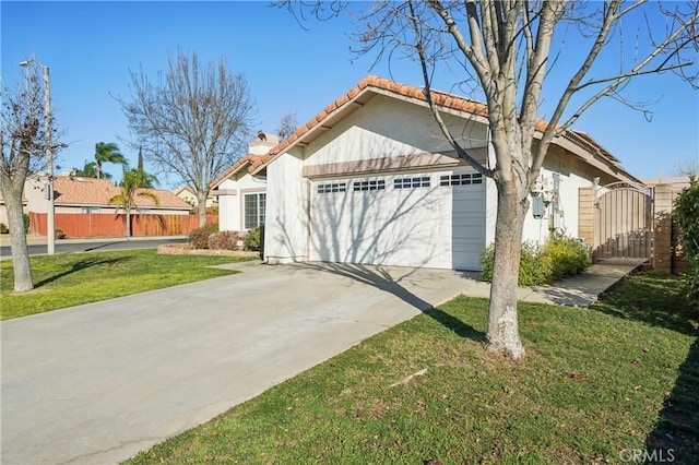 view of front facade with a garage and a front lawn