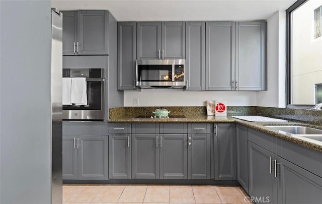 kitchen featuring gray cabinetry and stainless steel appliances