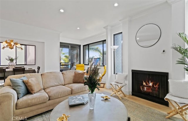 living room featuring light wood-type flooring and crown molding