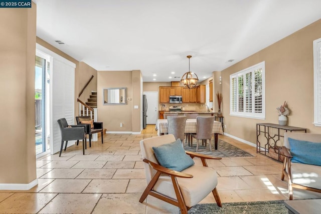 living room with an inviting chandelier and sink