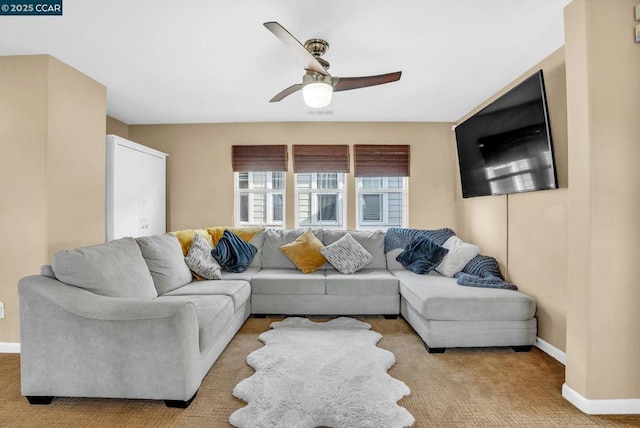 carpeted living room featuring ceiling fan