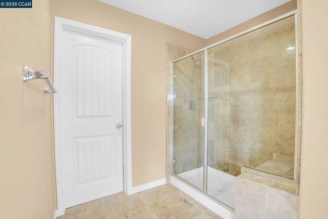 bathroom featuring a shower with door