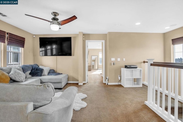 carpeted living room featuring ceiling fan