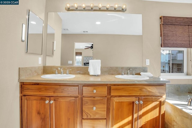 bathroom featuring ceiling fan and vanity