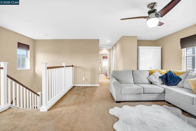 living room featuring ceiling fan and light colored carpet