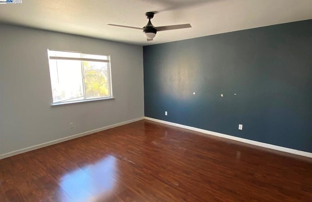 unfurnished room with ceiling fan and dark hardwood / wood-style flooring