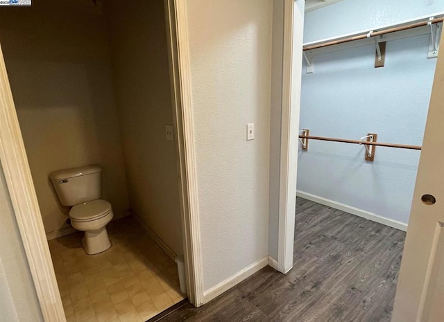 bathroom with wood-type flooring and toilet